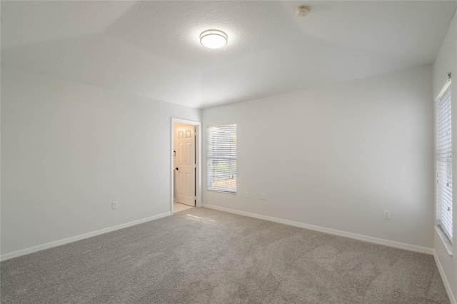 carpeted spare room featuring a textured ceiling