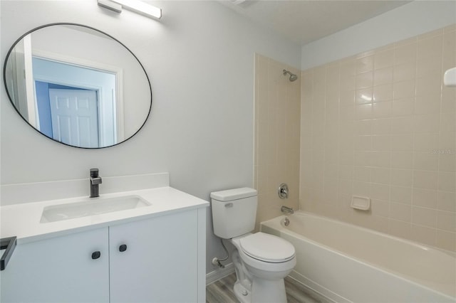 full bathroom featuring vanity, wood-type flooring, toilet, and tiled shower / bath