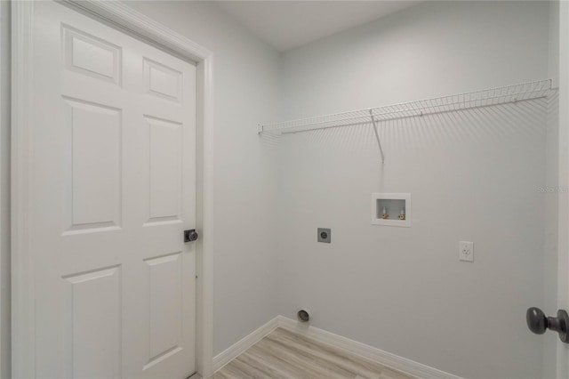 clothes washing area featuring hookup for a washing machine, electric dryer hookup, and light wood-type flooring