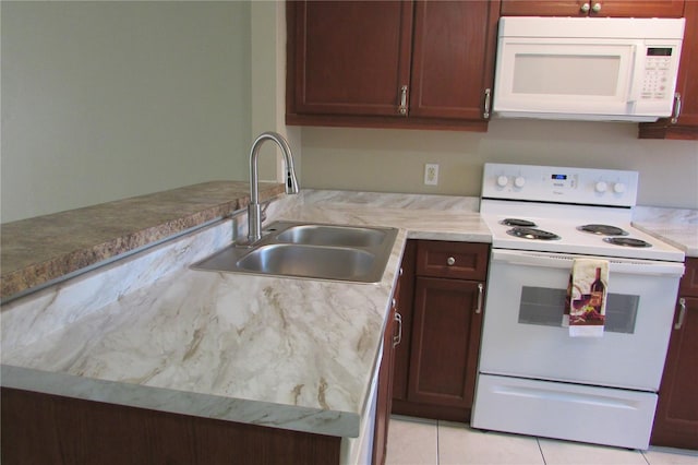 kitchen featuring a sink, white appliances, light tile patterned flooring, and light countertops