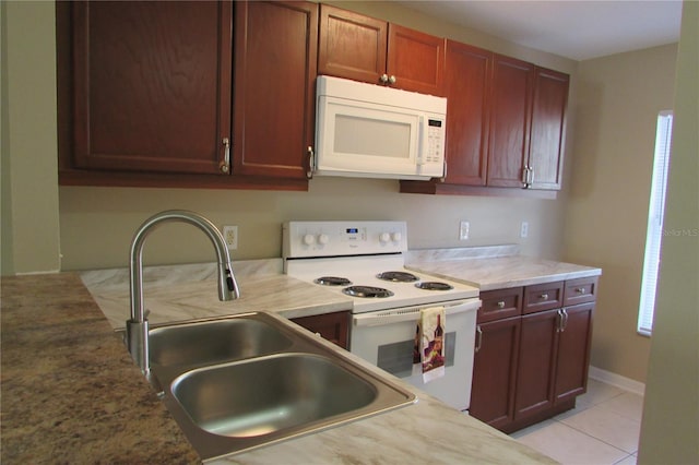 kitchen with sink, white appliances, and light tile patterned floors