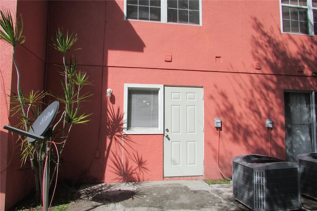 doorway to property with central AC unit