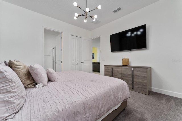 carpeted bedroom featuring a notable chandelier and a closet