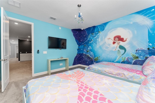 bedroom with carpet floors and a textured ceiling