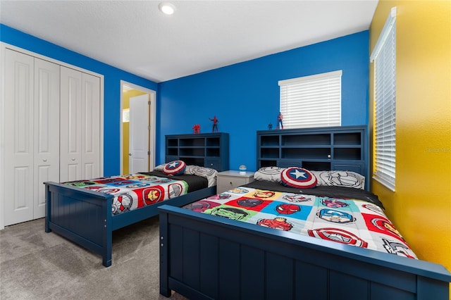 carpeted bedroom with a closet