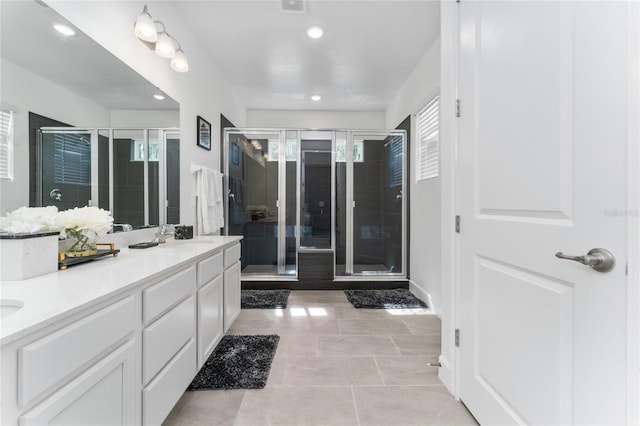 bathroom featuring tile patterned floors, vanity, and a shower with shower door