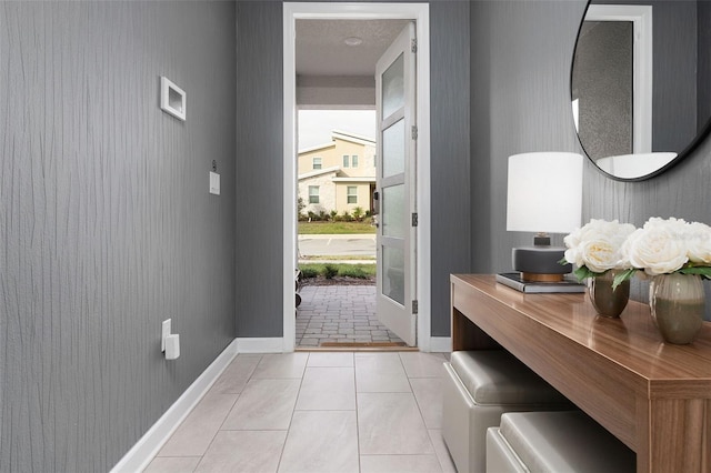 doorway with light tile patterned floors