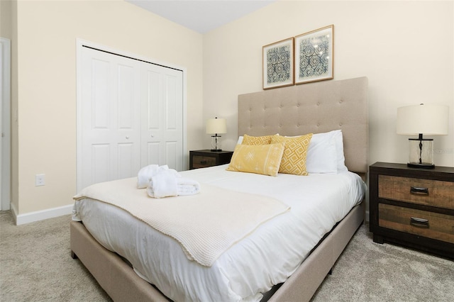 bedroom with light carpet and a closet