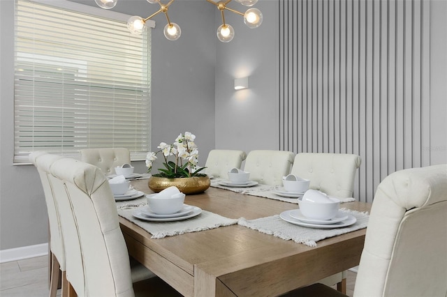 dining space with an inviting chandelier and light tile patterned floors