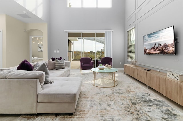 living room featuring a towering ceiling