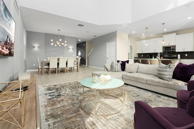 living room featuring a high ceiling and a notable chandelier