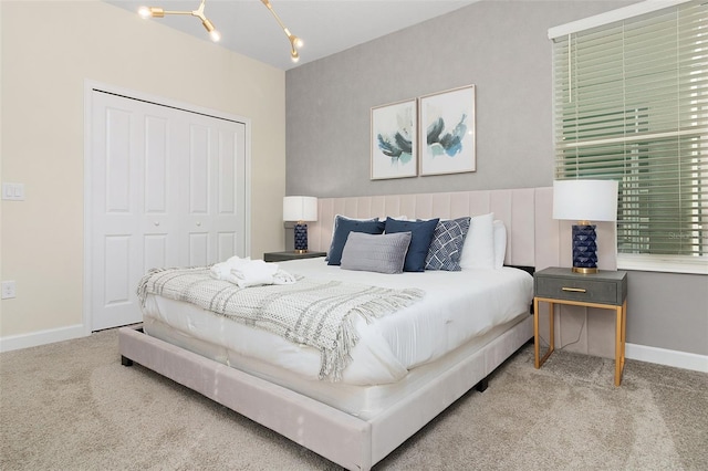 bedroom featuring an inviting chandelier, a closet, and carpet