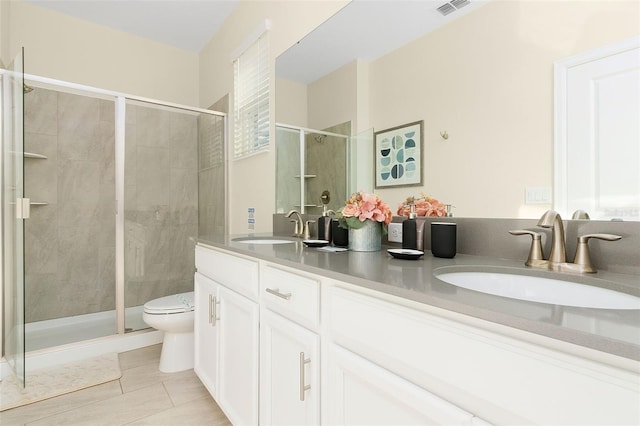 bathroom featuring tile patterned flooring, vanity, an enclosed shower, and toilet