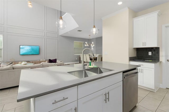 kitchen featuring sink, white cabinetry, stainless steel dishwasher, pendant lighting, and a kitchen island with sink