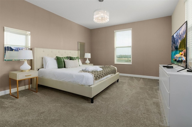 carpeted bedroom with a notable chandelier