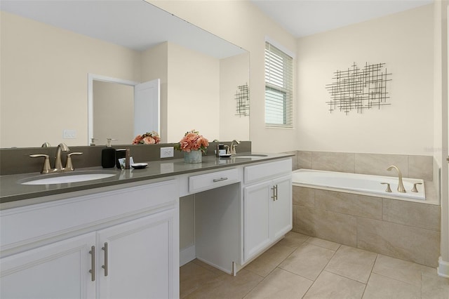 bathroom with vanity, tiled tub, and tile patterned flooring