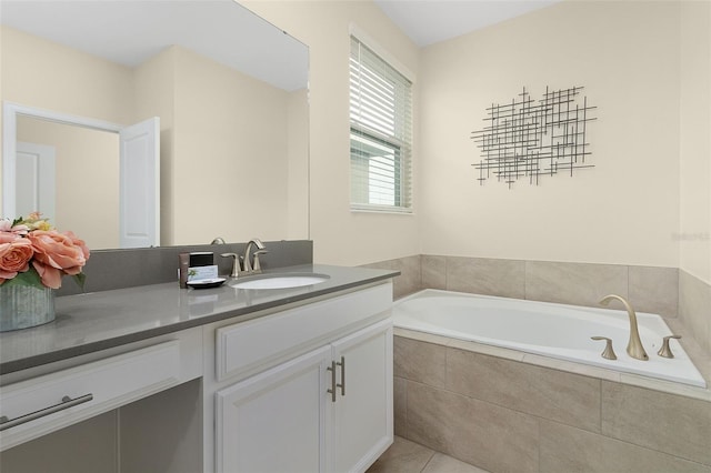 bathroom featuring vanity, tile patterned flooring, and a relaxing tiled tub