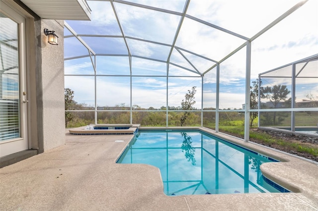 view of pool featuring an in ground hot tub, a lanai, and a patio