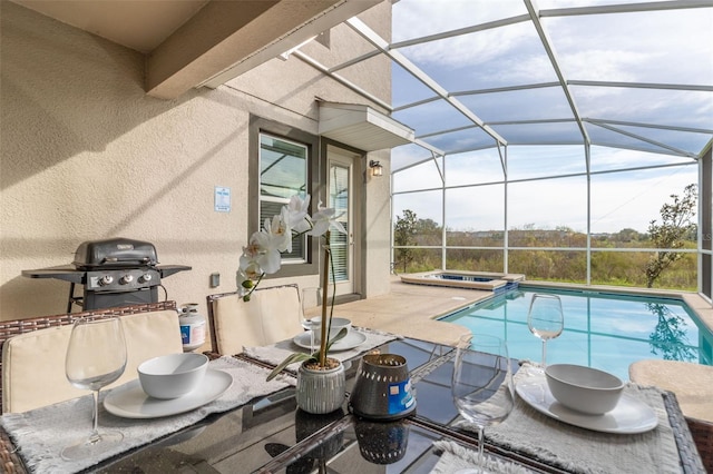 view of pool featuring an in ground hot tub, a lanai, and a patio area