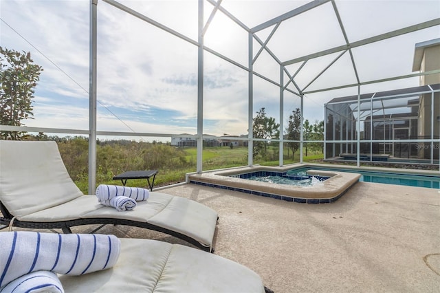 view of swimming pool with a lanai, a patio, and an in ground hot tub