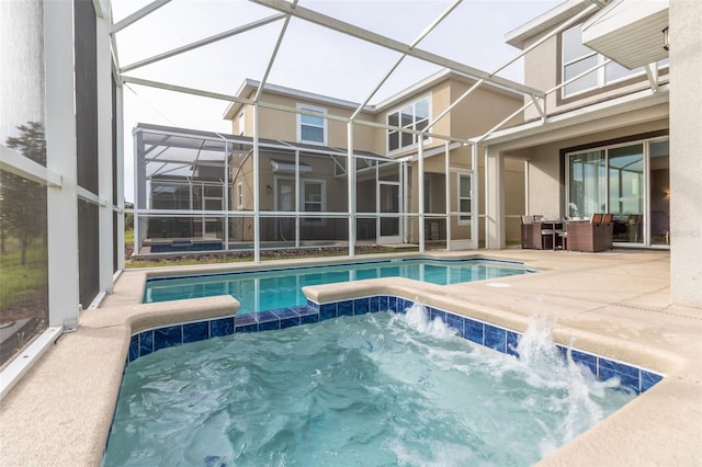 view of swimming pool with a patio and glass enclosure