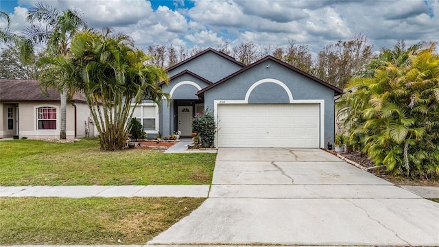 view of front of property with a garage and a front lawn