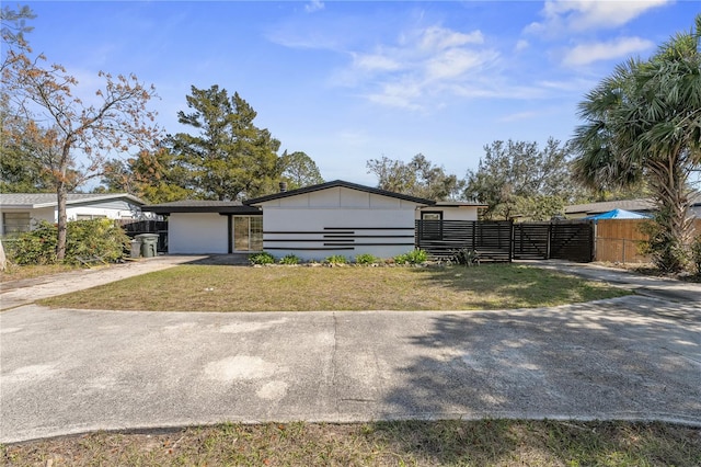 ranch-style home with a garage and a front yard