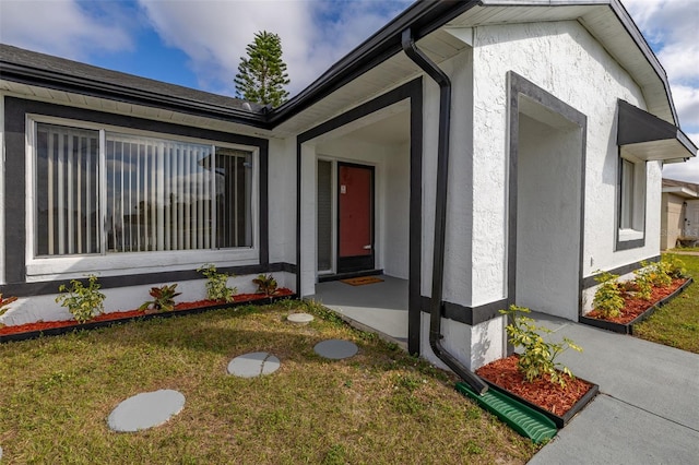 property entrance with a yard