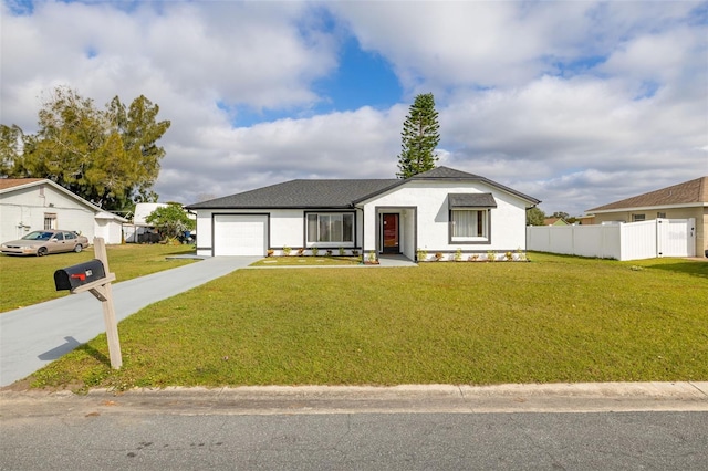 view of front of home with a garage and a front lawn