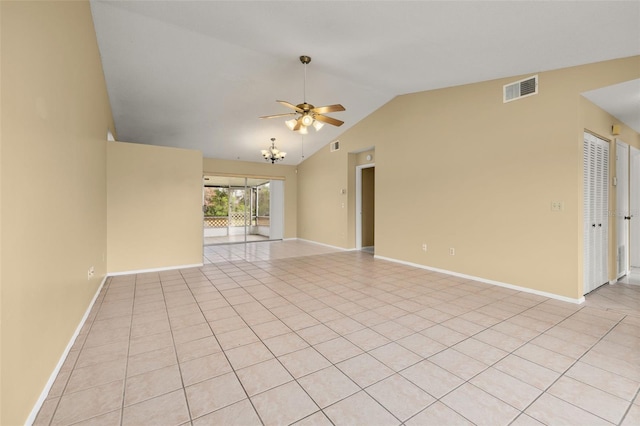 tiled empty room with lofted ceiling and ceiling fan with notable chandelier