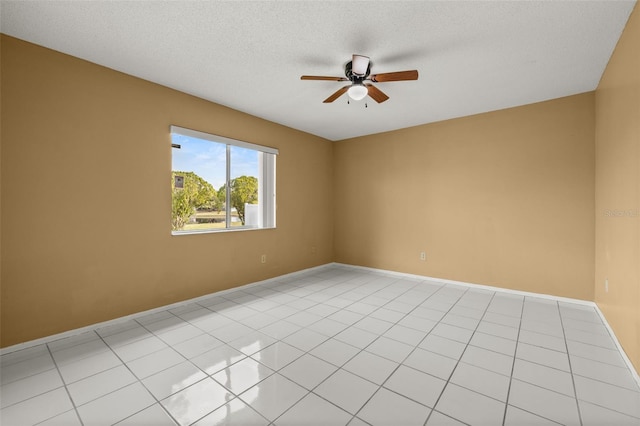 tiled spare room featuring a textured ceiling and ceiling fan