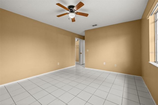 spare room featuring light tile patterned floors and ceiling fan