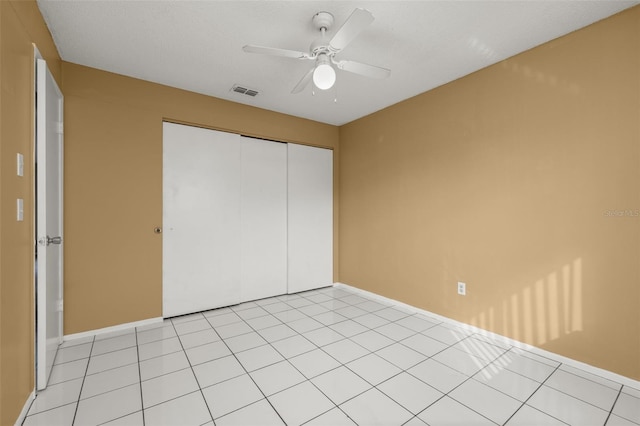 unfurnished bedroom with a closet, ceiling fan, and light tile patterned flooring