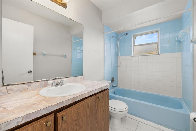 full bathroom featuring vanity, toilet, tiled shower / bath combo, and tile patterned flooring