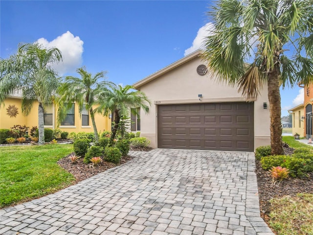 view of front of house featuring a garage and a front yard