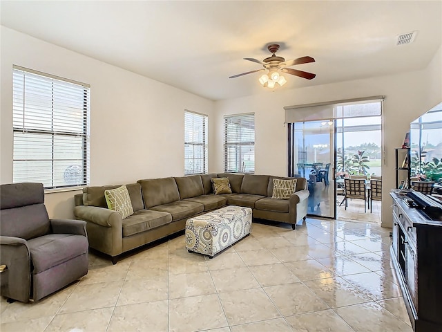 tiled living room with ceiling fan