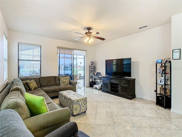 tiled living room with ceiling fan