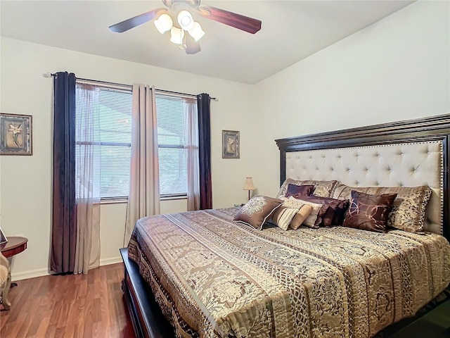 bedroom with wood-type flooring and ceiling fan