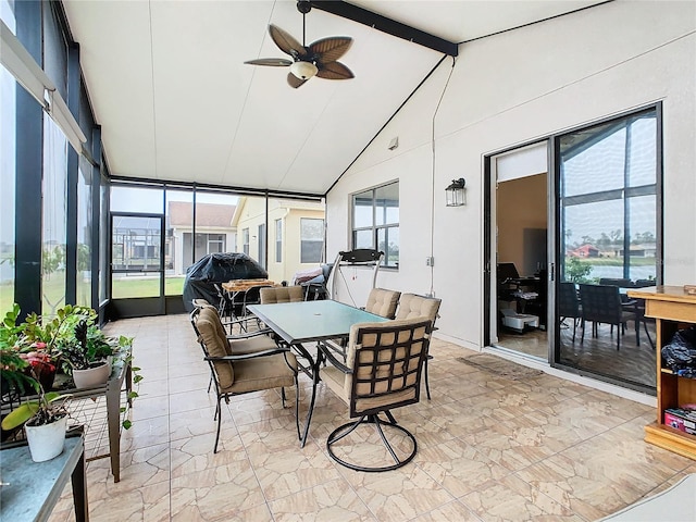 sunroom featuring lofted ceiling with beams and ceiling fan