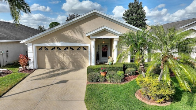 view of front of property with a garage and a front lawn