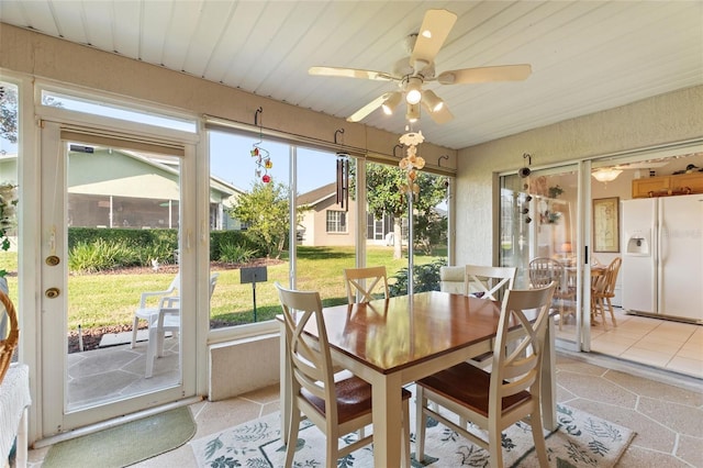 sunroom / solarium with plenty of natural light and ceiling fan