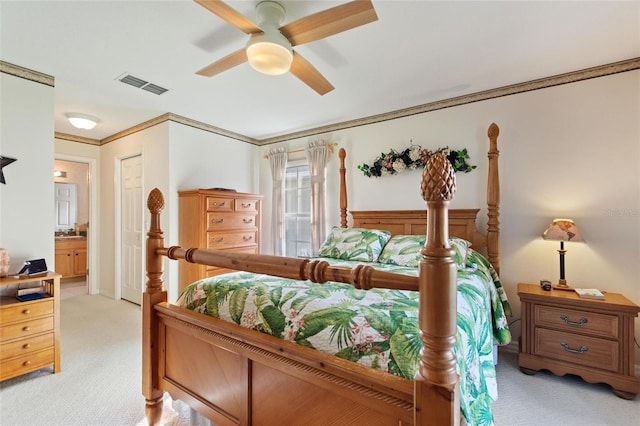 carpeted bedroom featuring connected bathroom, ornamental molding, and ceiling fan