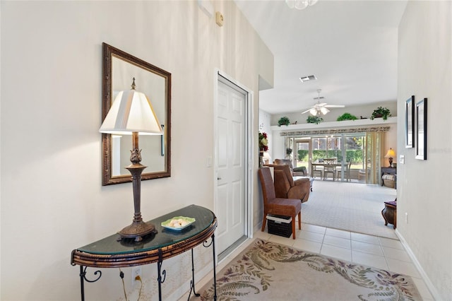 hall with light tile patterned floors