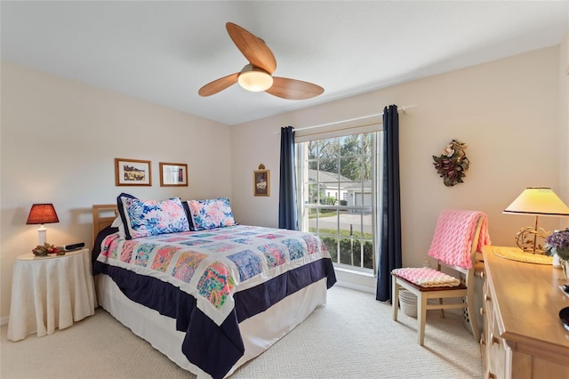 bedroom featuring ceiling fan and light colored carpet