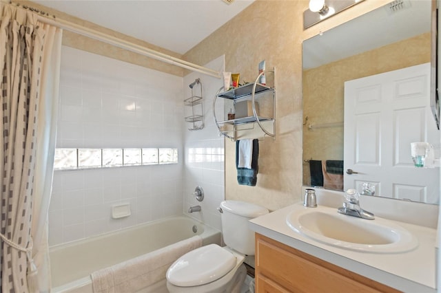 full bathroom with shower / tub combo with curtain, vanity, and toilet