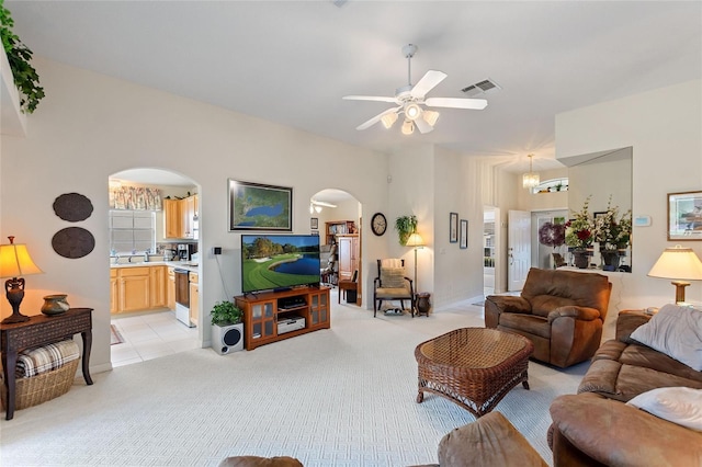 living room featuring light colored carpet and ceiling fan