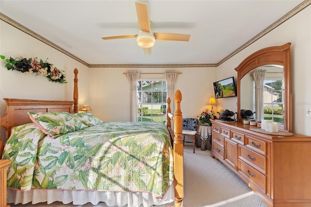 carpeted bedroom with ceiling fan and ornamental molding