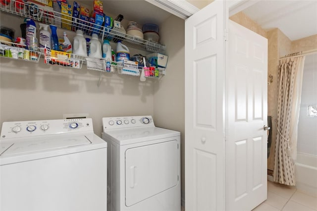 laundry area with light tile patterned floors and independent washer and dryer