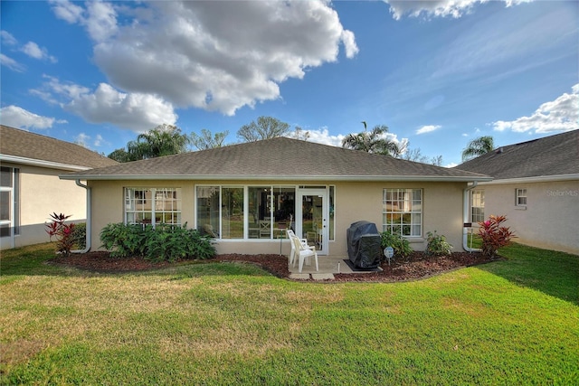 rear view of property featuring a yard