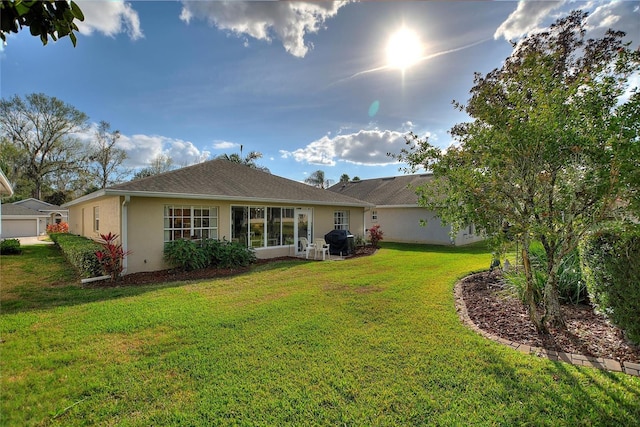 rear view of property featuring a lawn